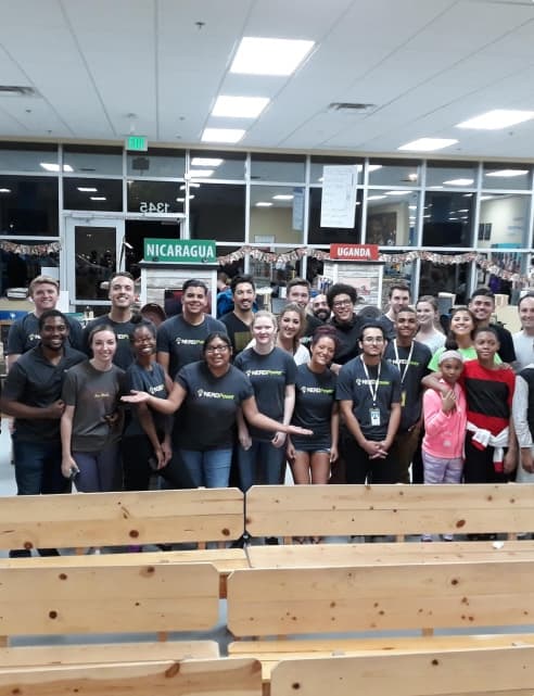 A group of people in black shirts standing in a room.